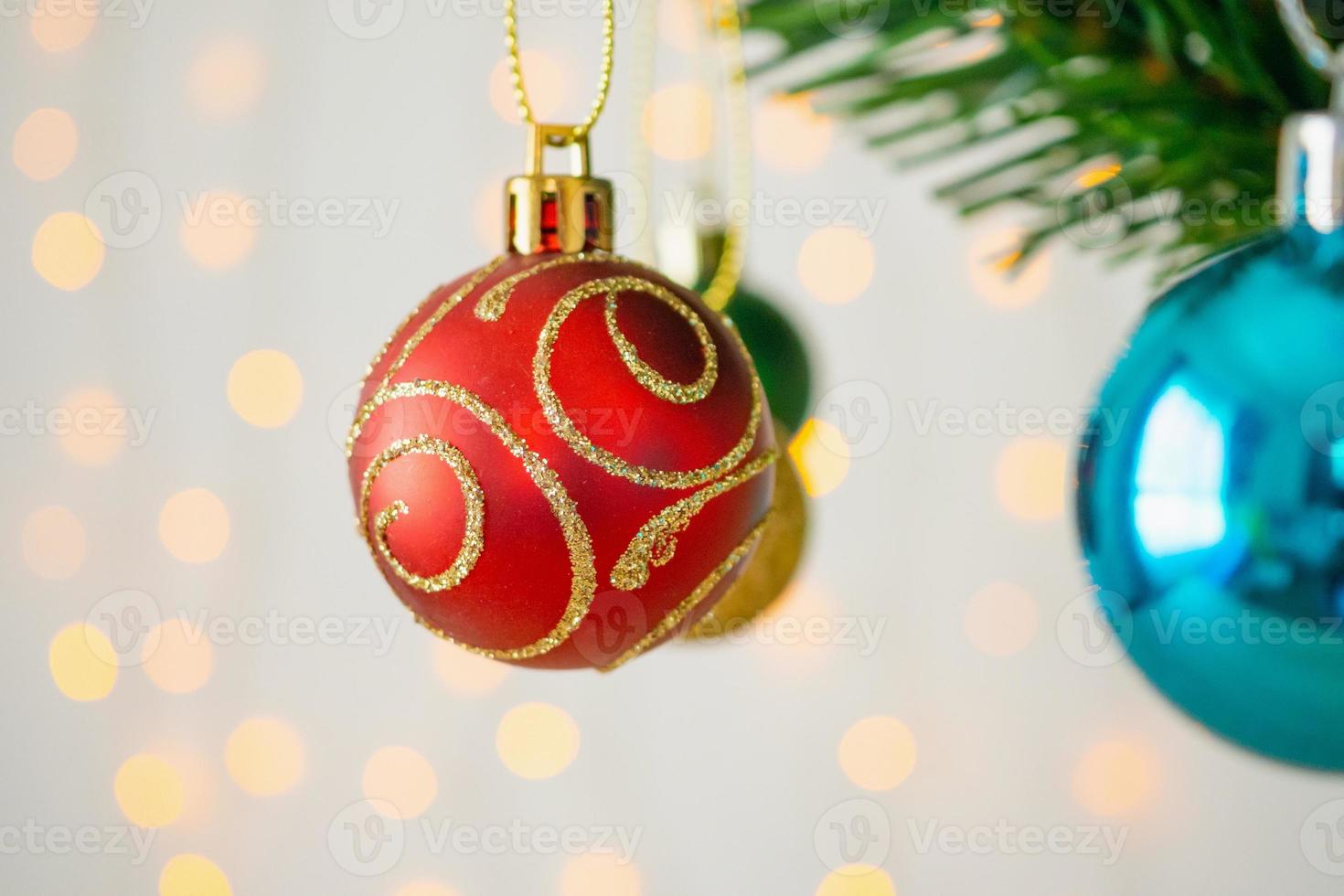 Christmas tree decorated with red ball on pine branches background photo