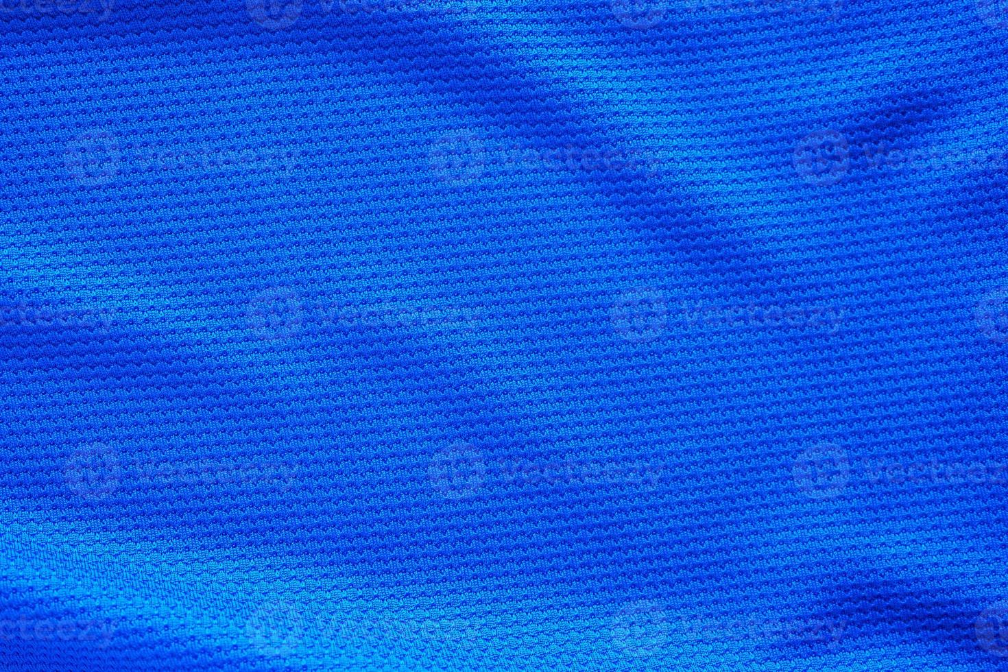 Blue football jersey clothing fabric texture sports wear background, close up top view photo
