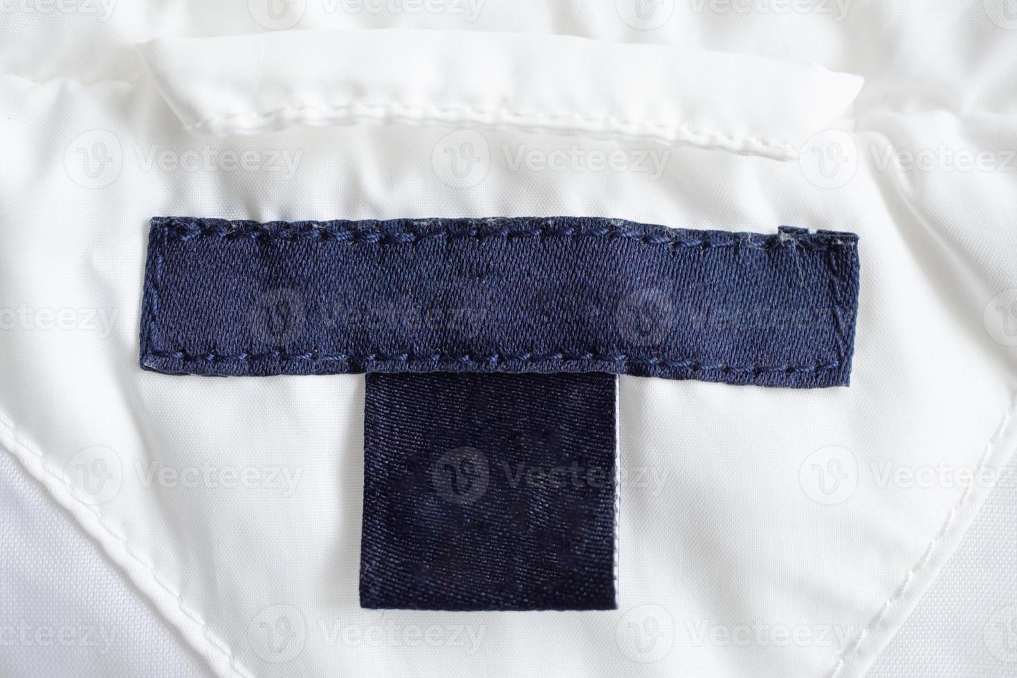 Blank laundry care clothing label on fabric texture photo