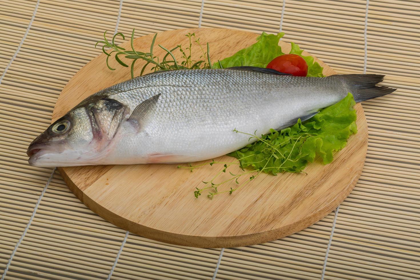Raw seabass on wood photo
