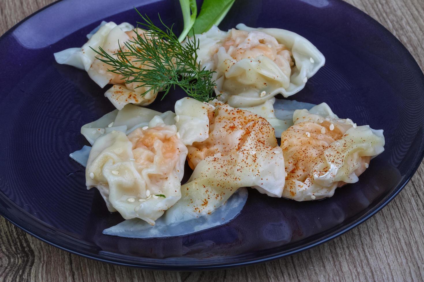 Shrimp wanton on the plate and wooden background photo