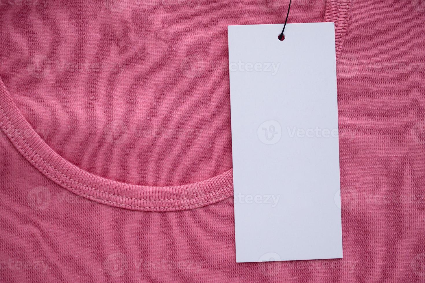 Blank white clothes tag label on new shirt photo