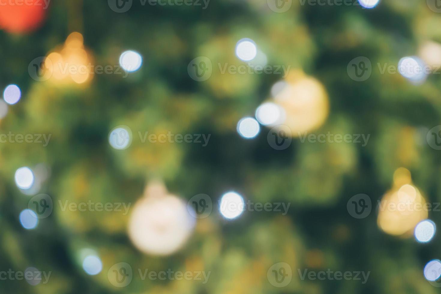 Abstract christmas holiday with festive gold bokeh light on tree blurred background photo