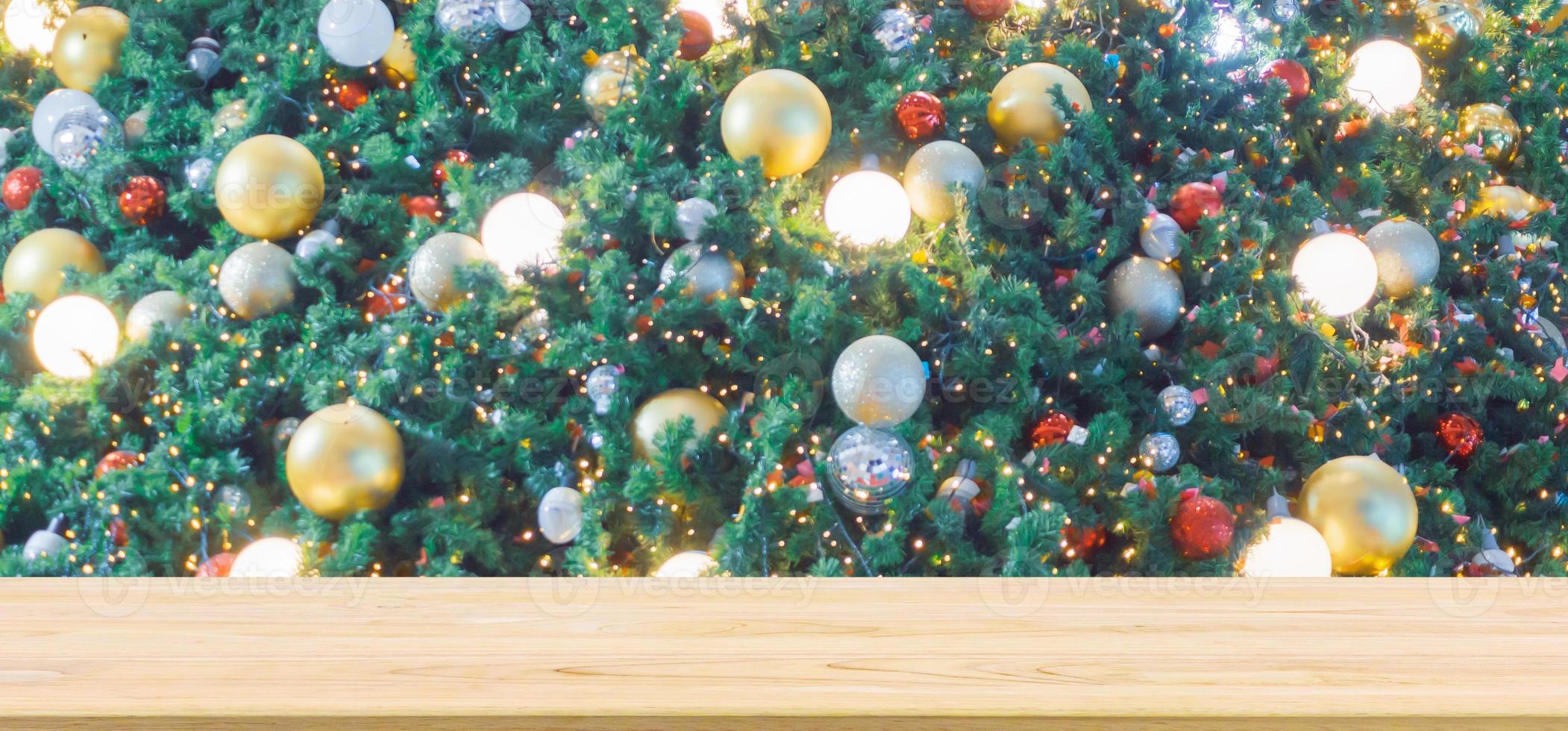 Empty wood table top with Abstract blur Christmas tree with decoration bokeh light background for product display photo