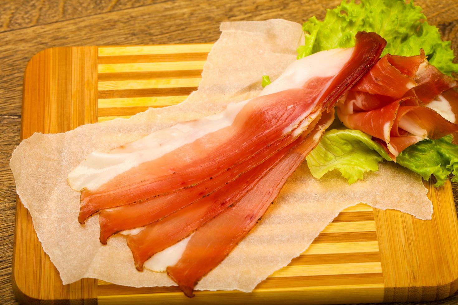 Hamon on wooden board and wooden background photo