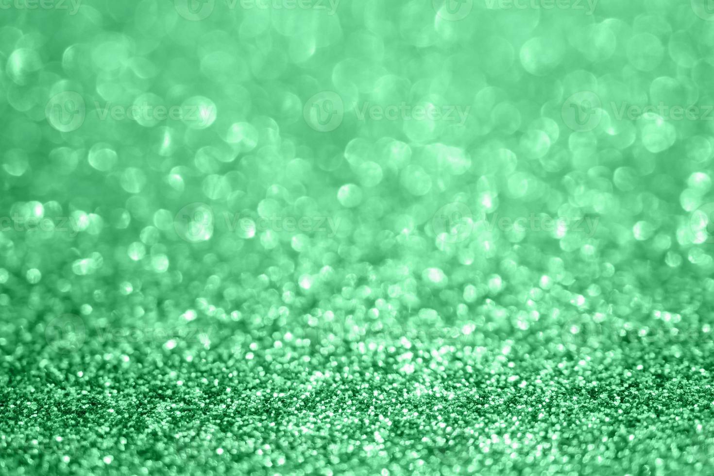 Abstract blur green glitter sparkle defocused bokeh light background photo