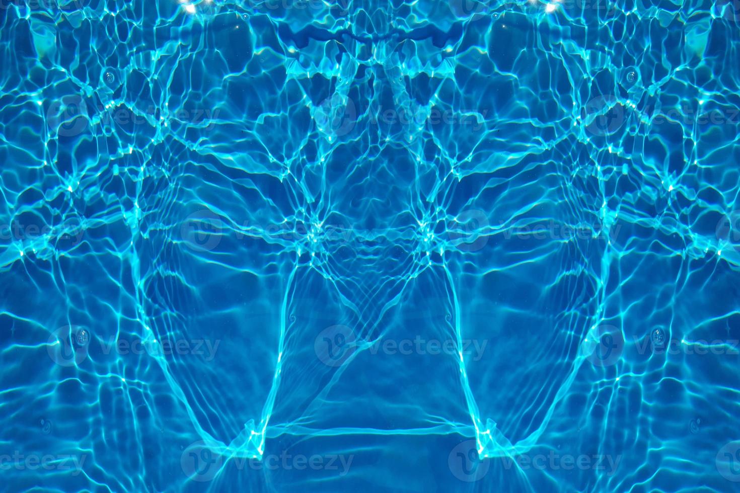 Defocus blurred transparent blue colored clear calm water surface texture with splash, bubble. Shining blue water ripple background. Surface of water in swimming pool. Blue bubble water shining. photo