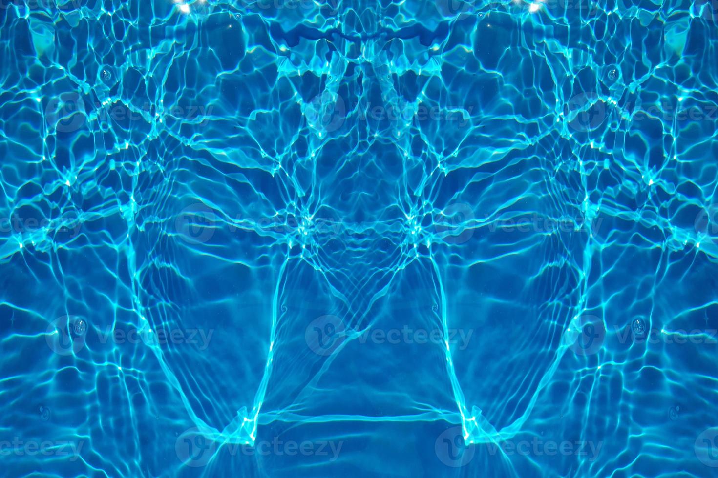 Defocus blurred transparent blue colored clear calm water surface texture with splash, bubble. Shining blue water ripple background. Surface of water in swimming pool. Blue bubble water shining. photo