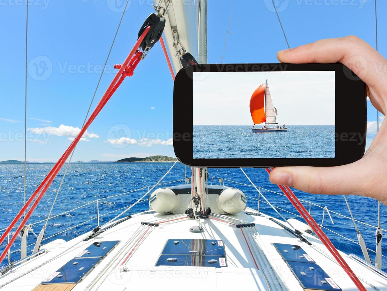 tourist taking photo of red yacht in Adriatic sea