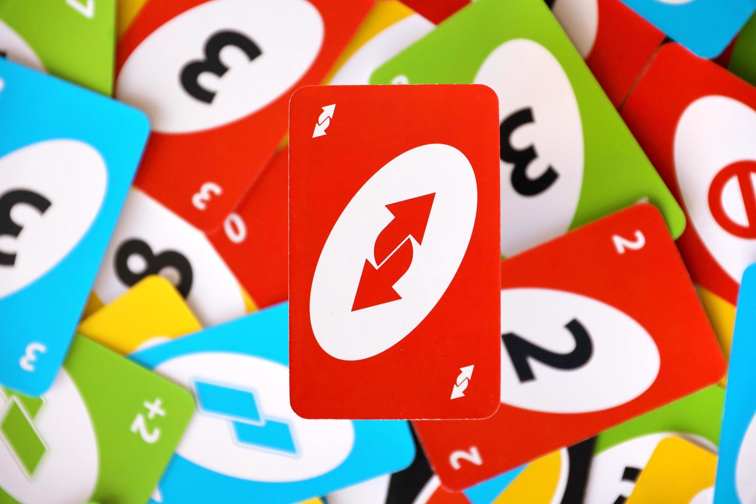 TERNOPIL, UKRAINE - MAY 15, 2022 Many colorful UNO game cards. UNO is an American shedding-type card game that is played with a specially printed deck photo