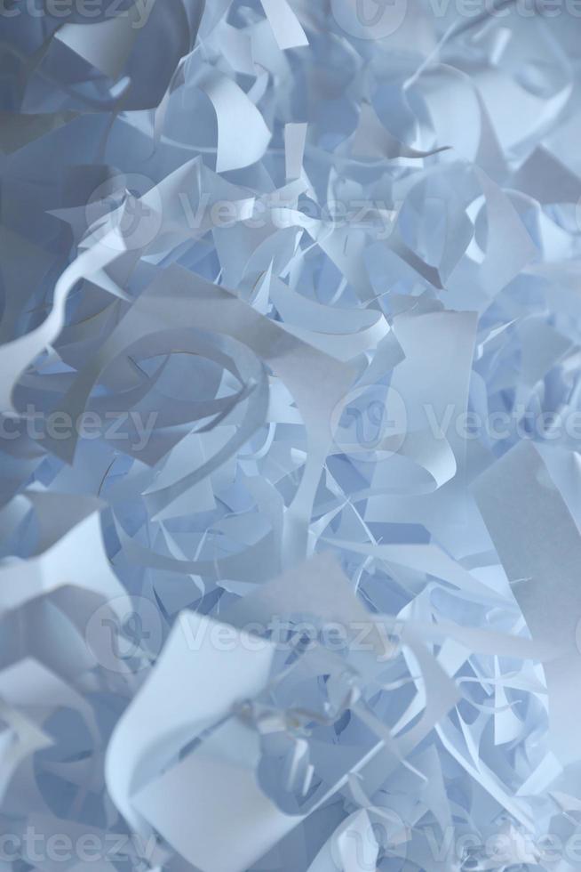 Shredded paper texture background, top view of many white paper strips. Pile of cut paper like box filler for shipping fragile items photo