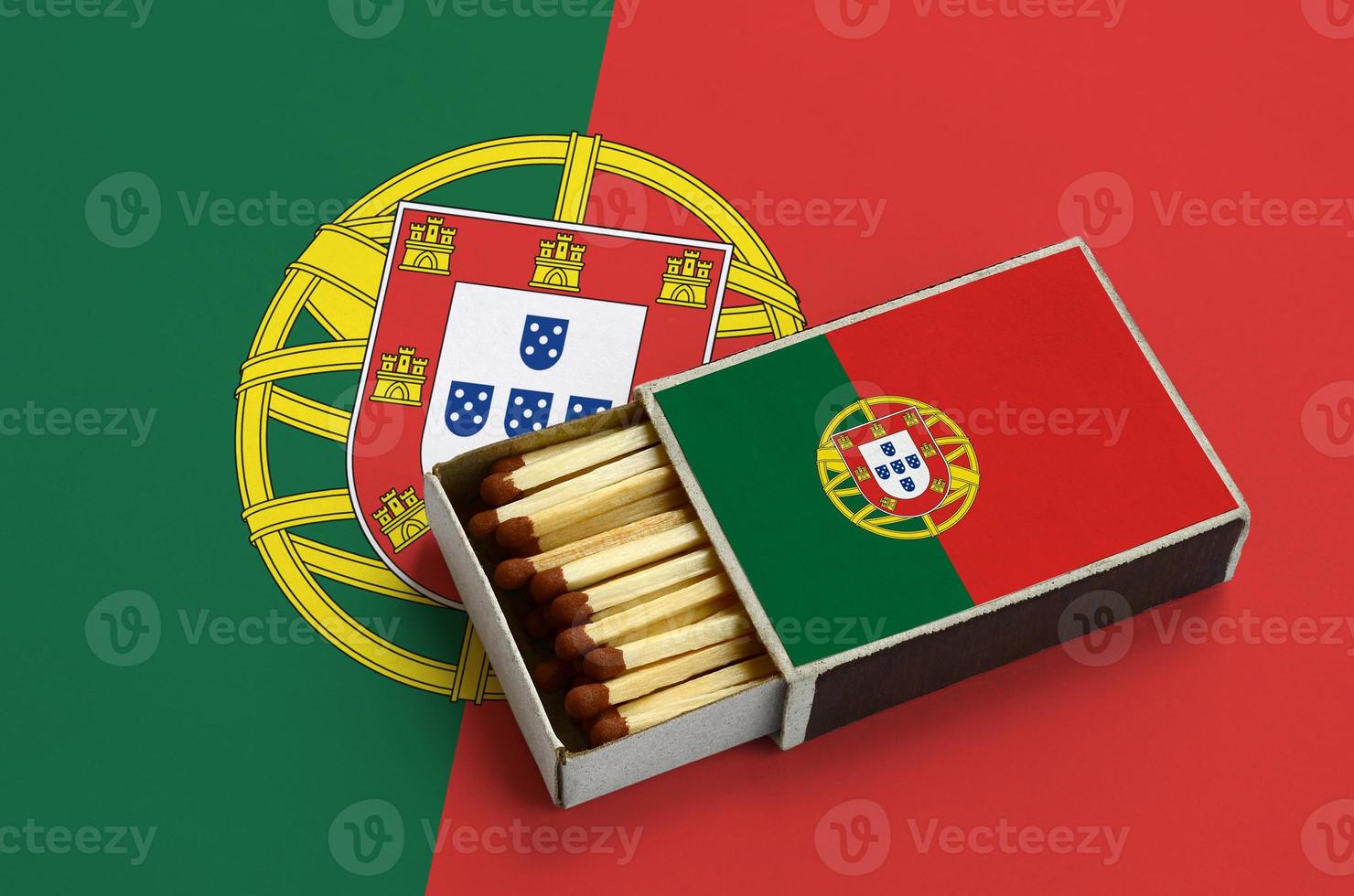 Portugal flag  is shown in an open matchbox, which is filled with matches and lies on a large flag photo