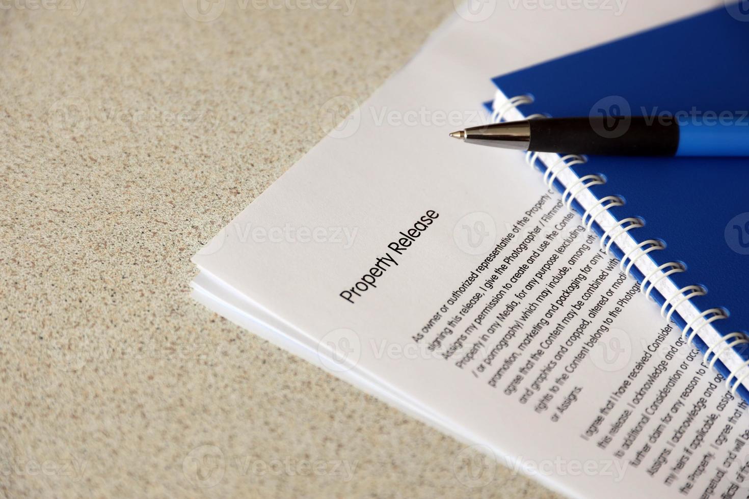 Property release blank form with blue notepad and blue pen lies on photographers table. Property release signing photo