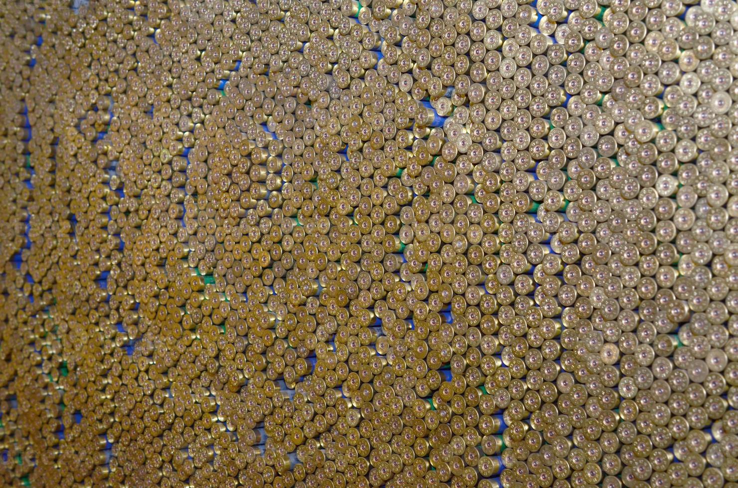 Pattern of 12 gauge cartridges for shotgun bullets. Shells for hunting rifle close up. Backdrop for shooting range or ammunition trade concepts photo