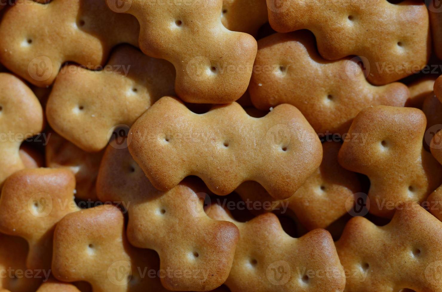 Macro photography of a many yellow salted cracker photo