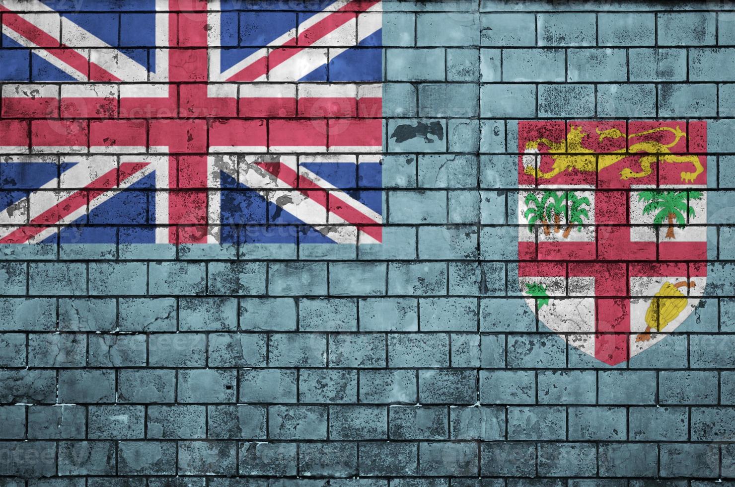 La bandera de fiji está pintada en una pared de ladrillo vieja foto