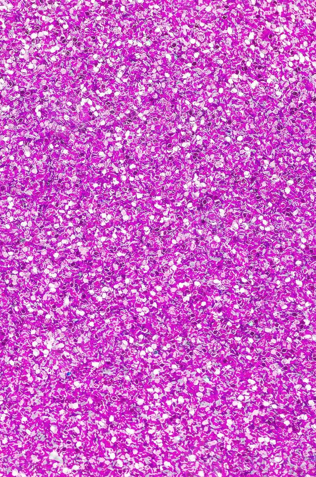 Pink decorative sequins. Background image with shiny bokeh lights from small elements photo