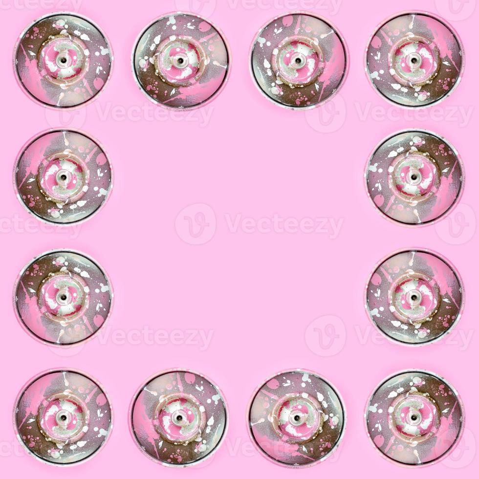 Many used spray cans for graffiti drawing lies on a pastel colored backgroung. Street art painting concept. Minimal flat lay pattern. Top view photo