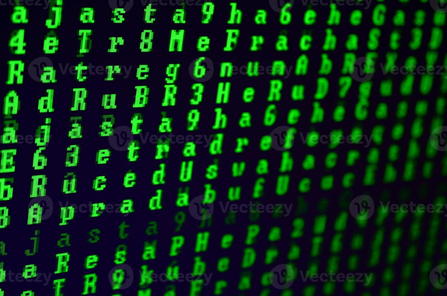 Macro shot of a glitch on the monitor of an office computer. The concept of introducing a virus into a personal data keeper. Stream of random green symbols on a black background photo
