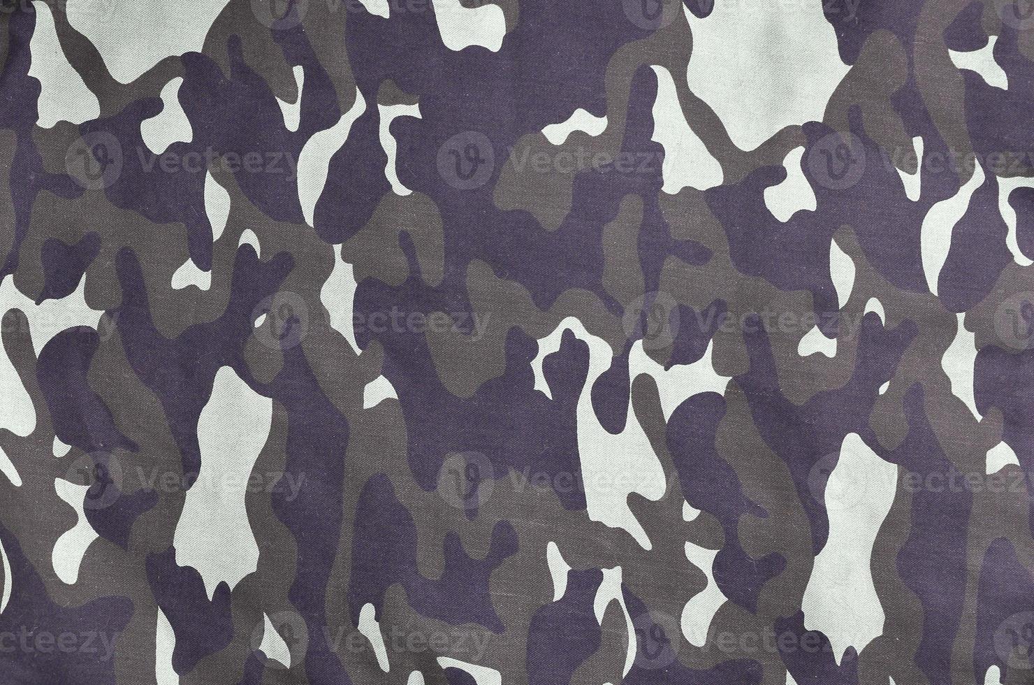 Texture of fabric with a camouflage painted in colors of the marsh. Army background image photo