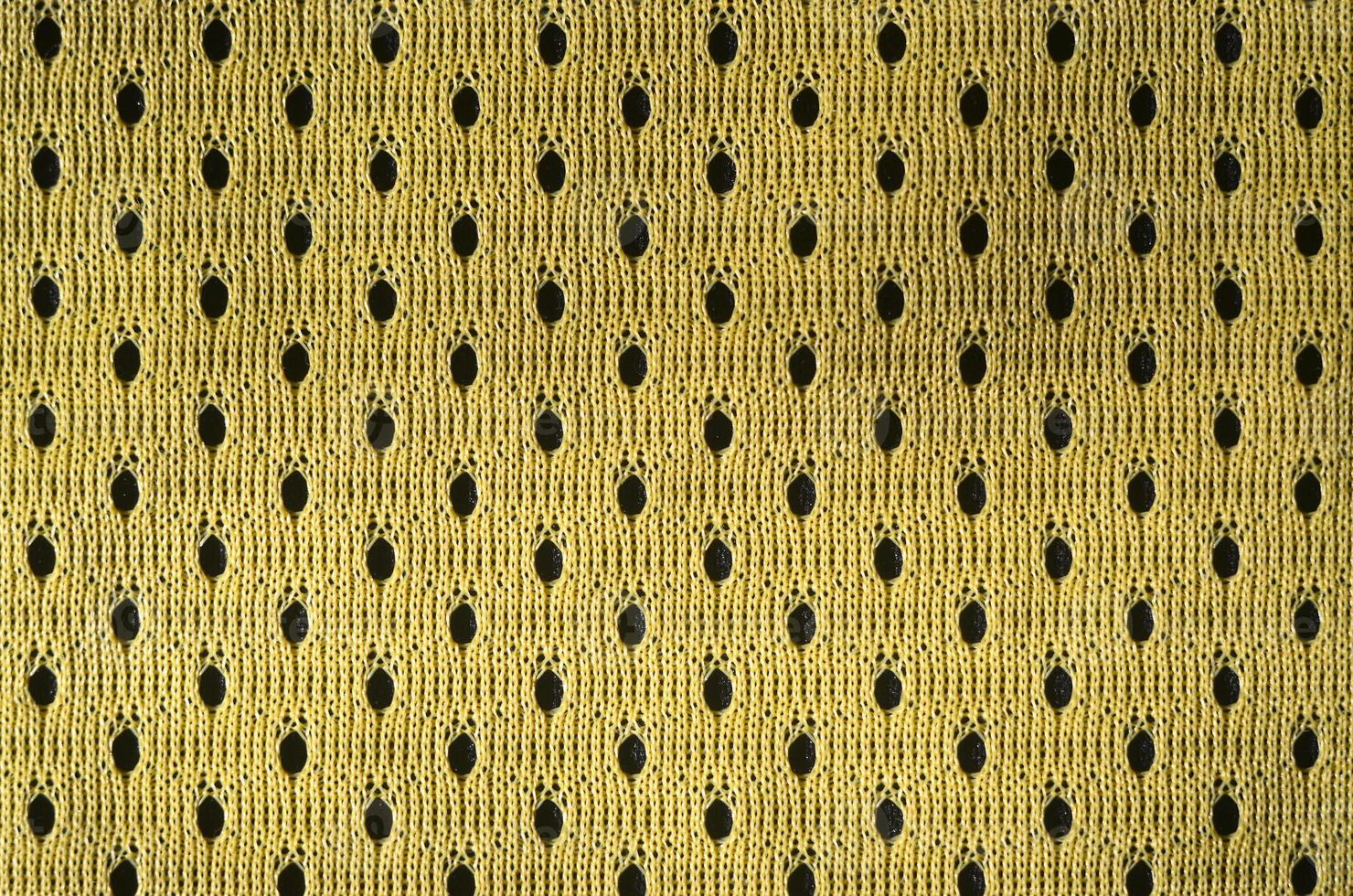 Close up of yellow polyester nylon yellow sportswear shorts to created a textured background photo