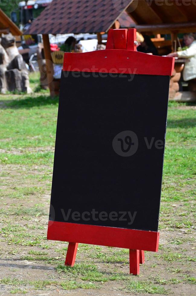 A large board as a menu for an open-air restaurant in a mountainous area. Free space for your text photo