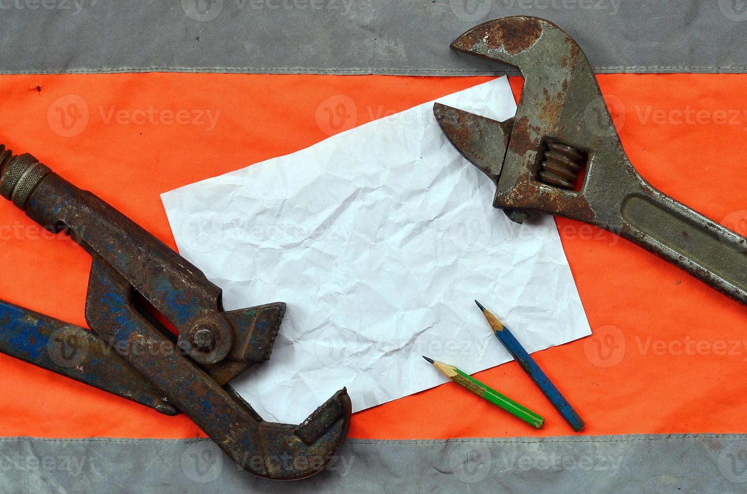 Adjustable wrenches and a sheet of paper with two pencils photo