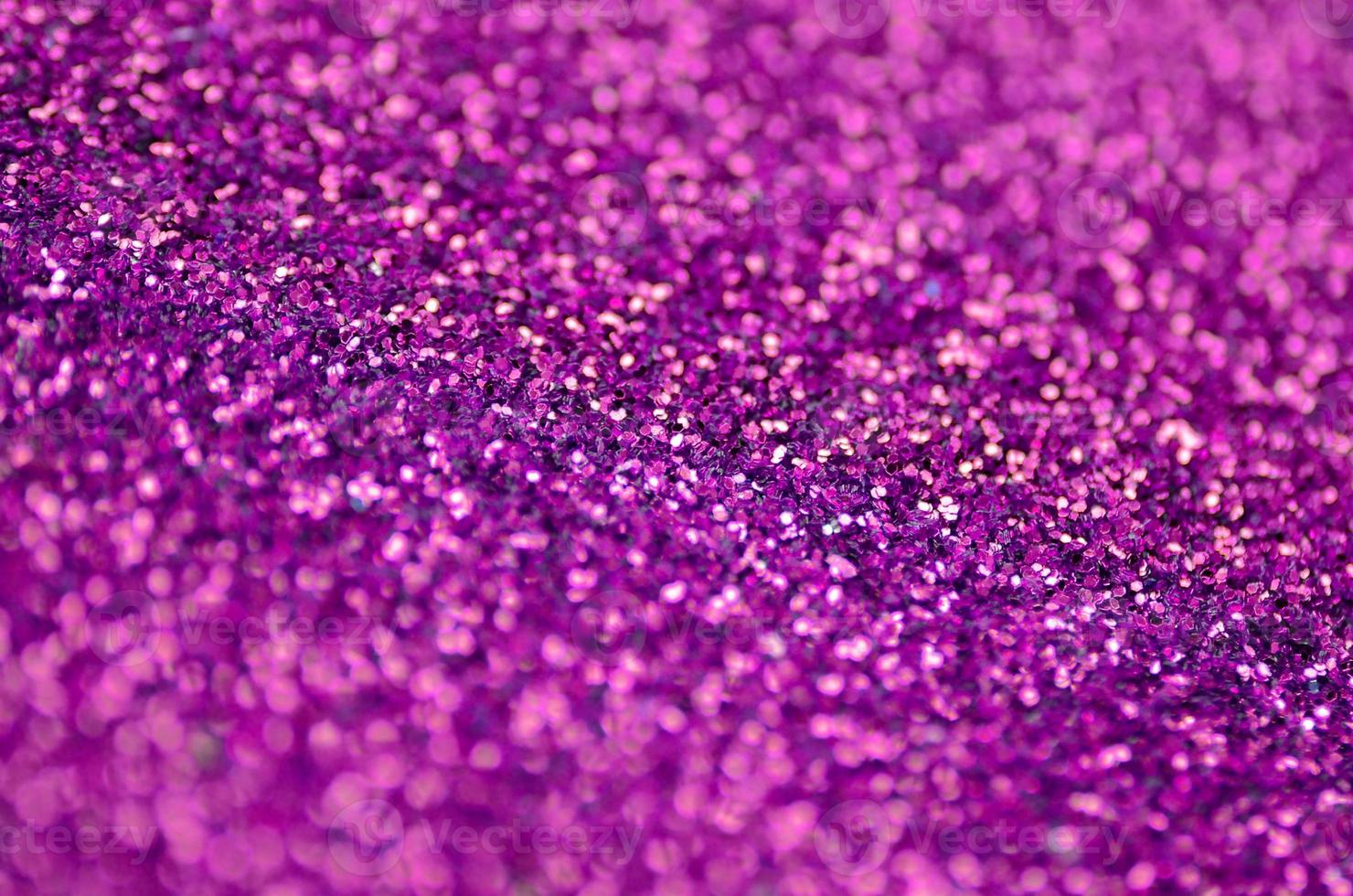 Pink decorative sequins. Background image with shiny bokeh lights from small elements photo