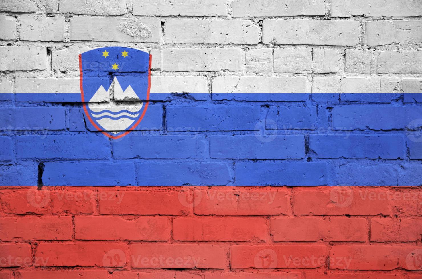 Slovenia flag is painted onto an old brick wall photo