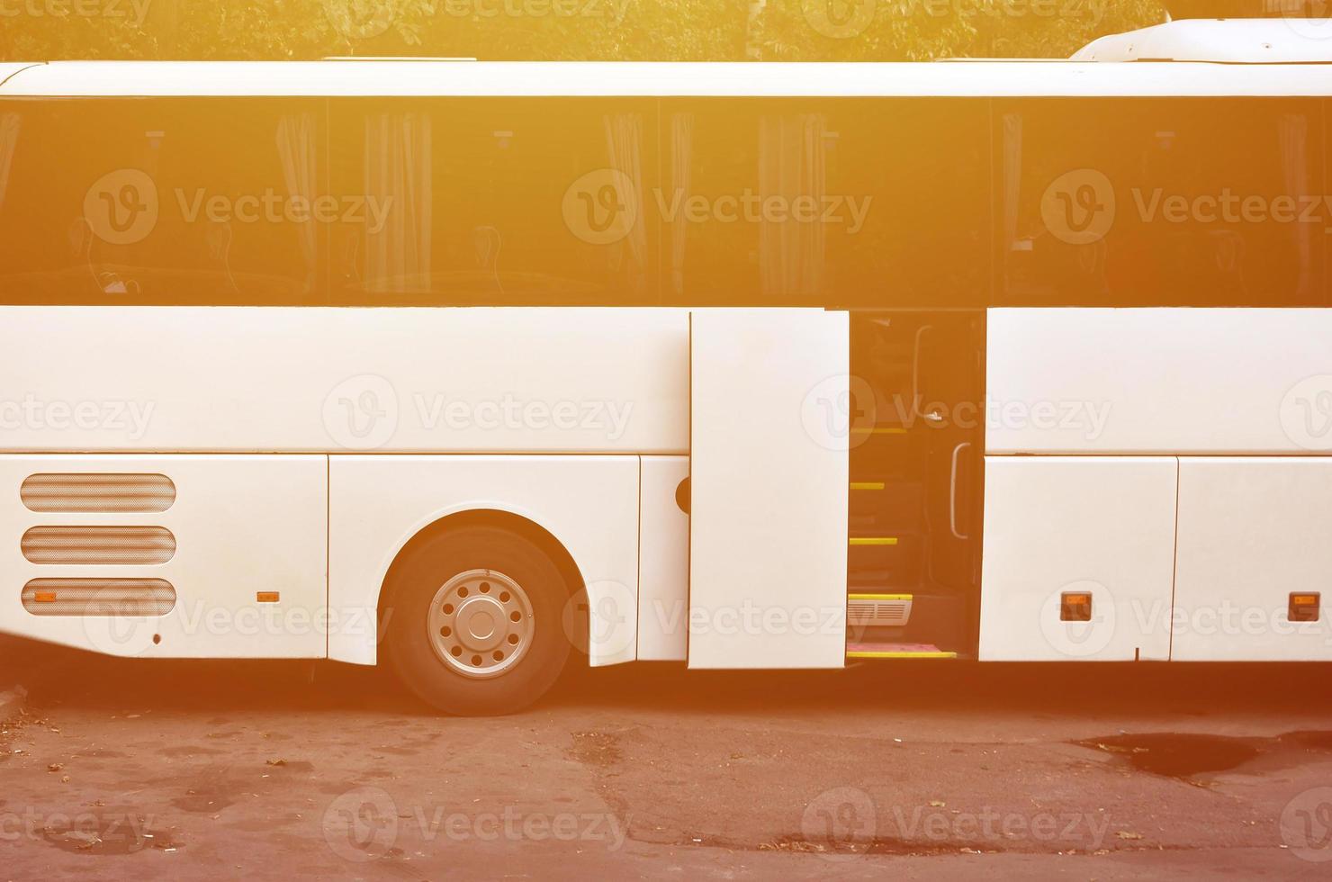 White tourist bus for excursions. The bus is parked in a parking lot near the park photo