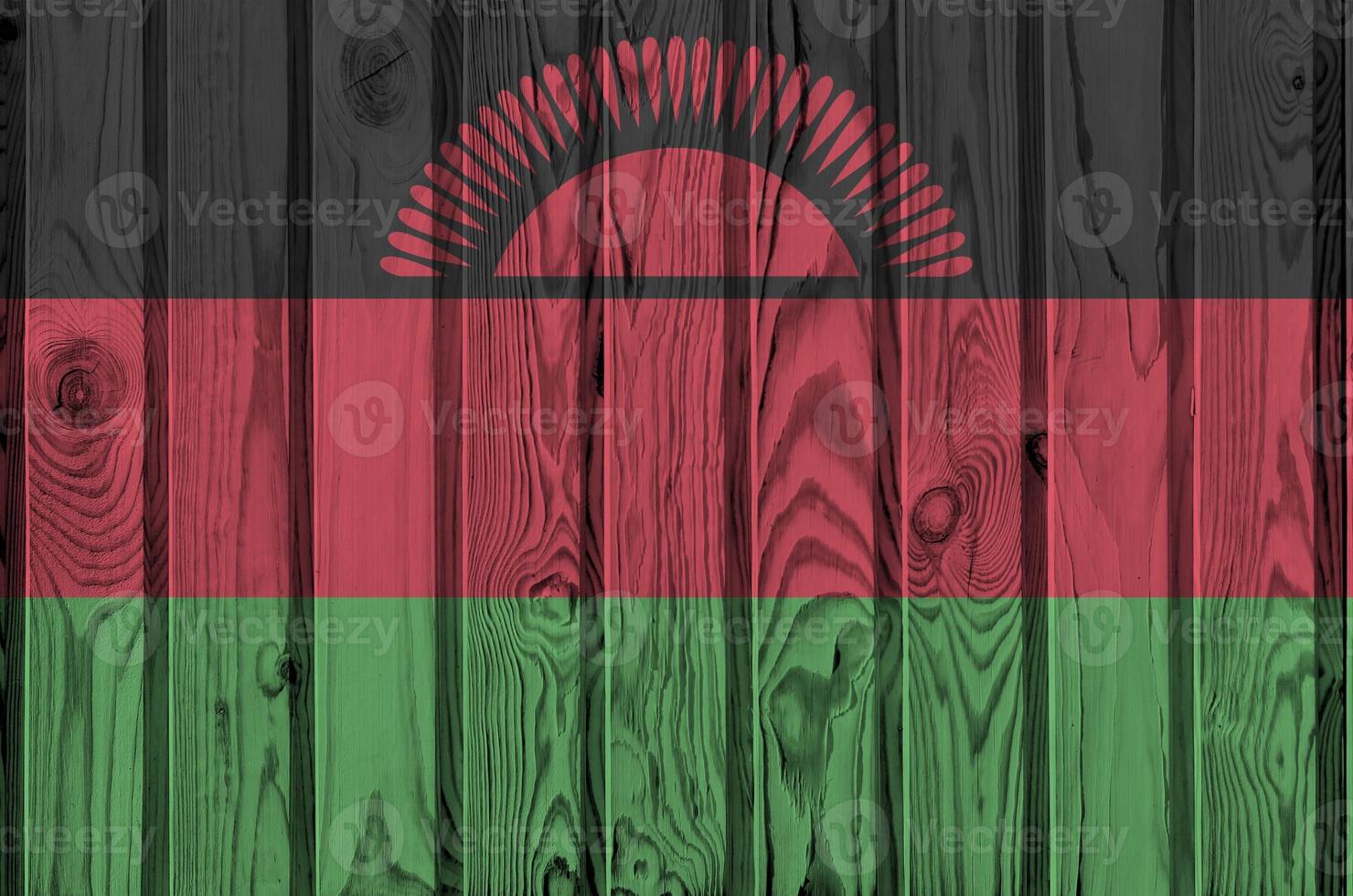 Malawi flag depicted in bright paint colors on old wooden wall. Textured banner on rough background photo