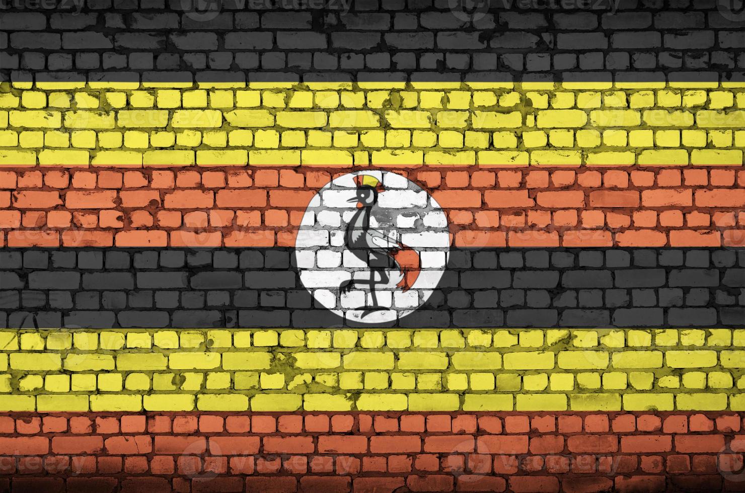 Uganda flag is painted onto an old brick wall photo