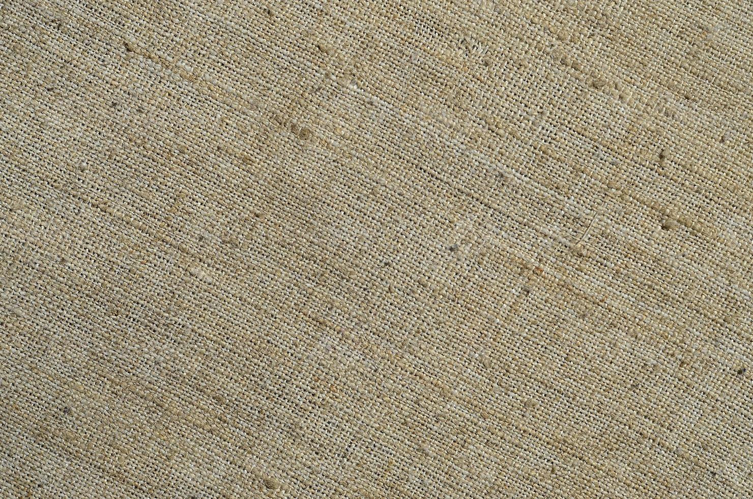 Texture of a gray canvas made of old and coarse burlap. Top view photo