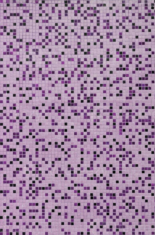 The texture of the wall, decorated with a mosaic of various small square tiles. Abstract pattern of ceramic tiles on the wall photo