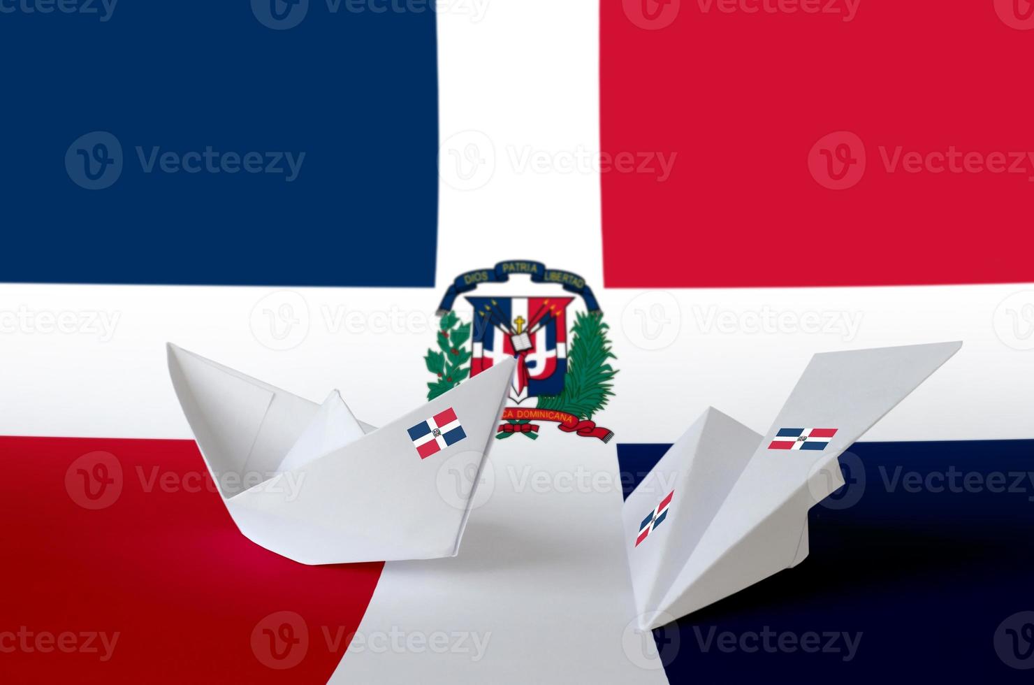 Dominican Republic flag depicted on paper origami airplane and boat. Handmade arts concept photo