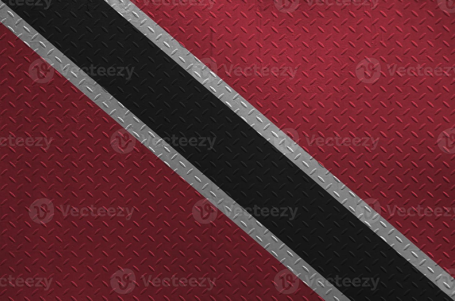 Trinidad and Tobago flag depicted in paint colors on old brushed metal plate or wall closeup. Textured banner on rough background photo