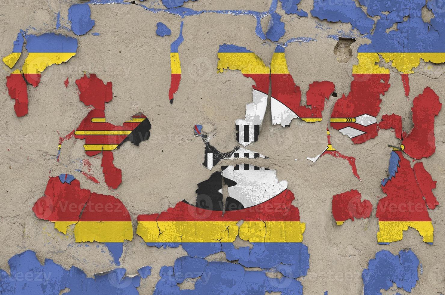 Swaziland flag depicted in paint colors on old obsolete messy concrete wall closeup. Textured banner on rough background photo