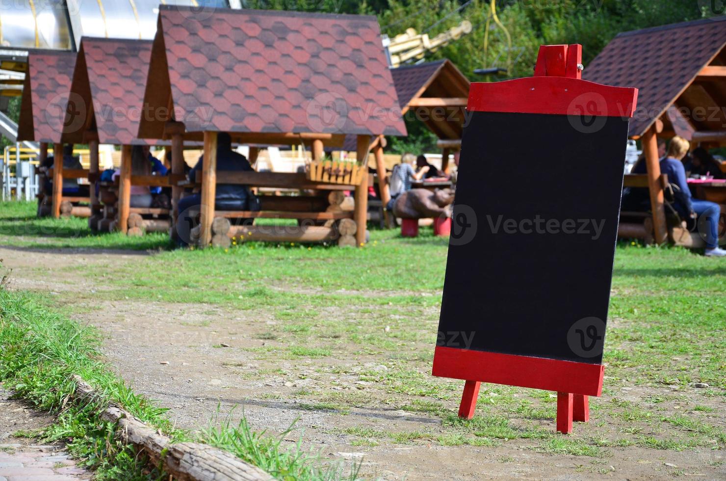A large board as a menu for an open-air restaurant in a mountainous area. Free space for your text photo