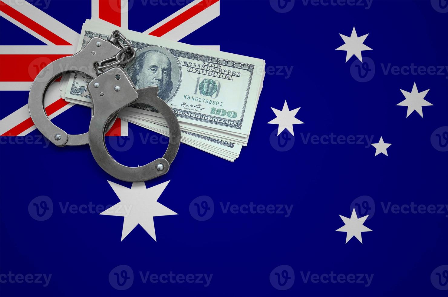 Australia flag  with handcuffs and a bundle of dollars. The concept of breaking the law and thieves crimes photo