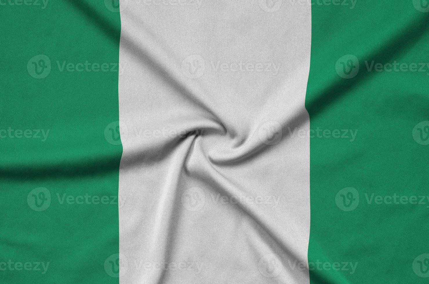 Nigeria flag  is depicted on a sports cloth fabric with many folds. Sport team banner photo