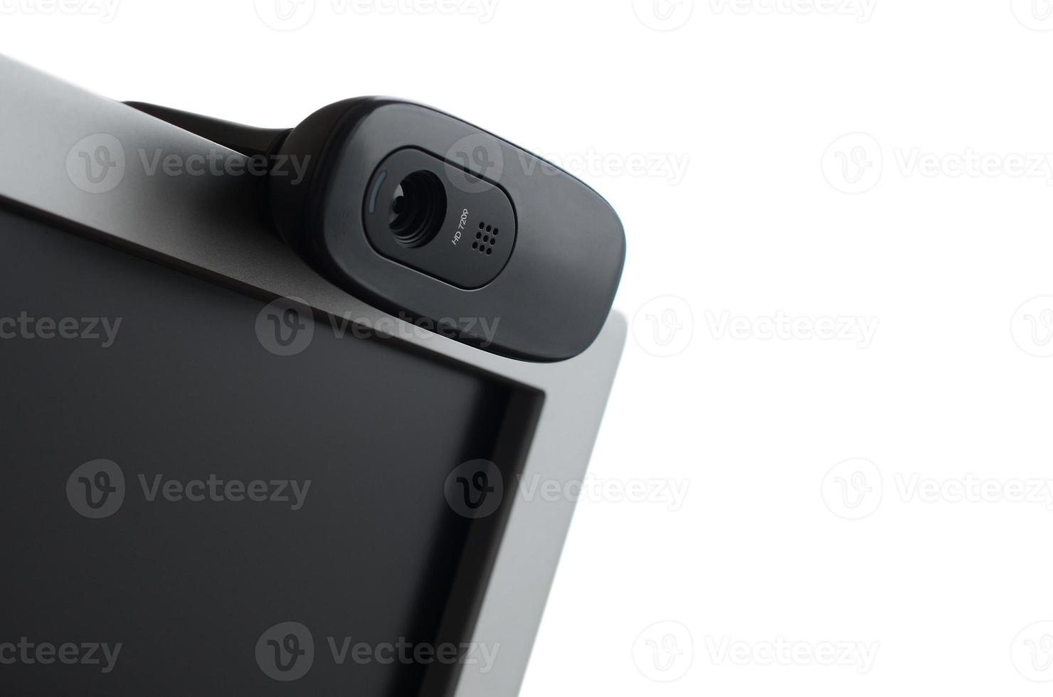 A modern web camera is installed on the body of a flat screen monitor. Device for video communication and recording of high quality video photo