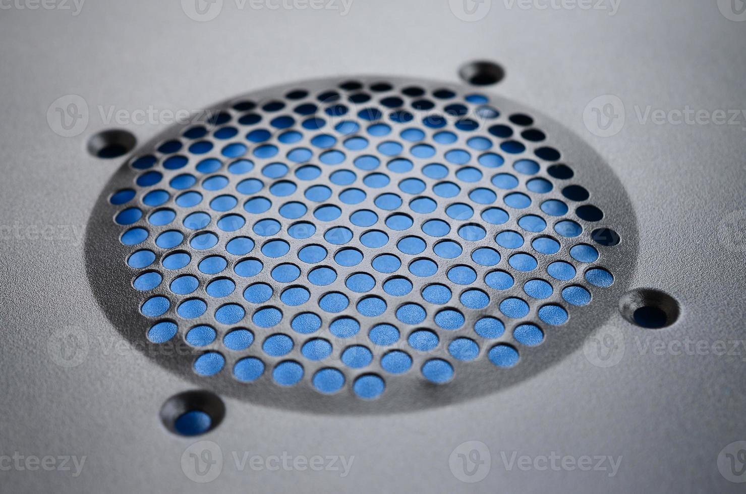 Close-up, shallow focus of a meshed style cooling panel used on a main frame computer. The circular holes aid active venting of hot air within the computer photo
