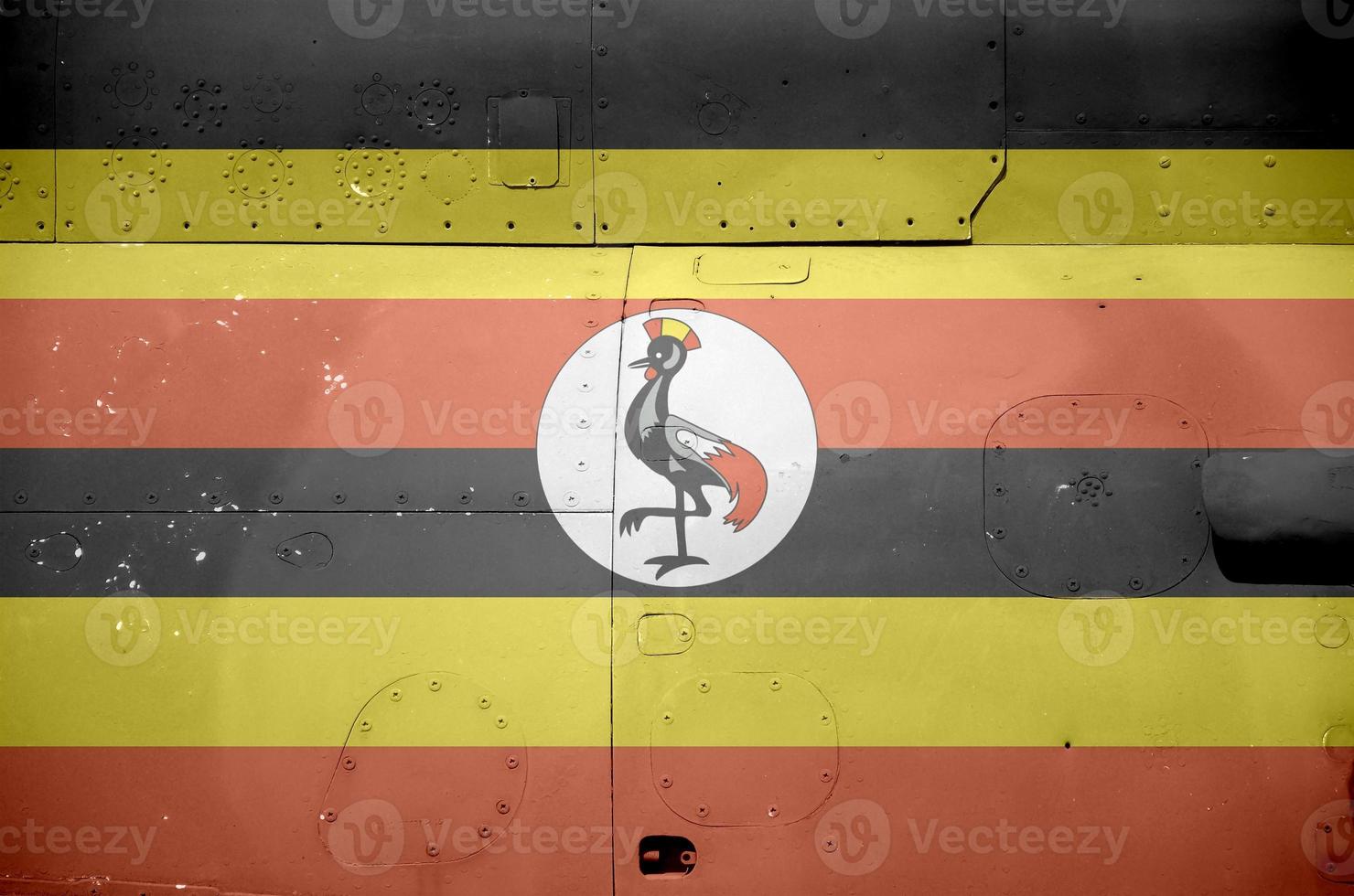 Uganda flag depicted on side part of military armored helicopter closeup. Army forces aircraft conceptual background photo