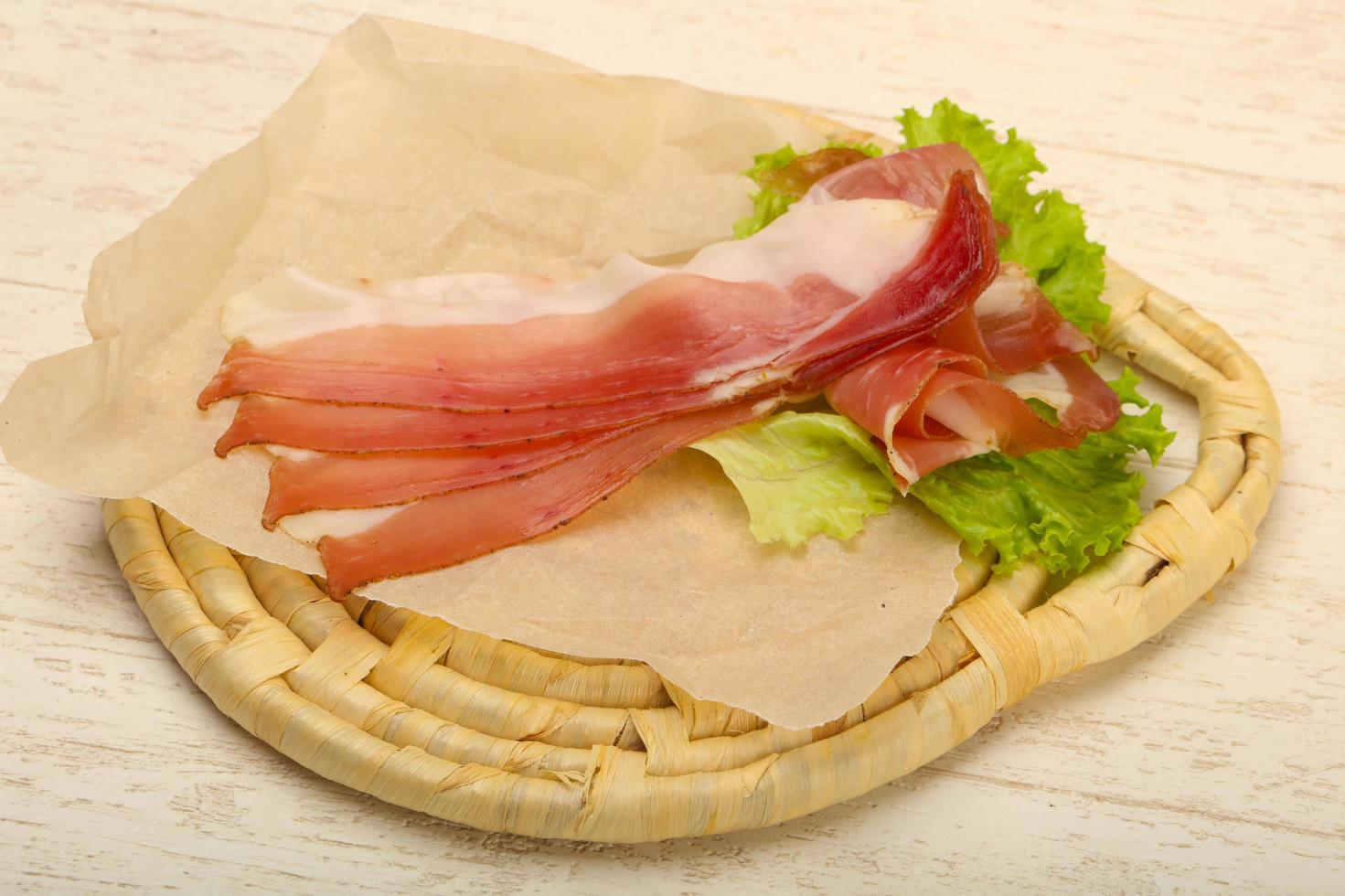 Hamon on wooden board and wooden background photo