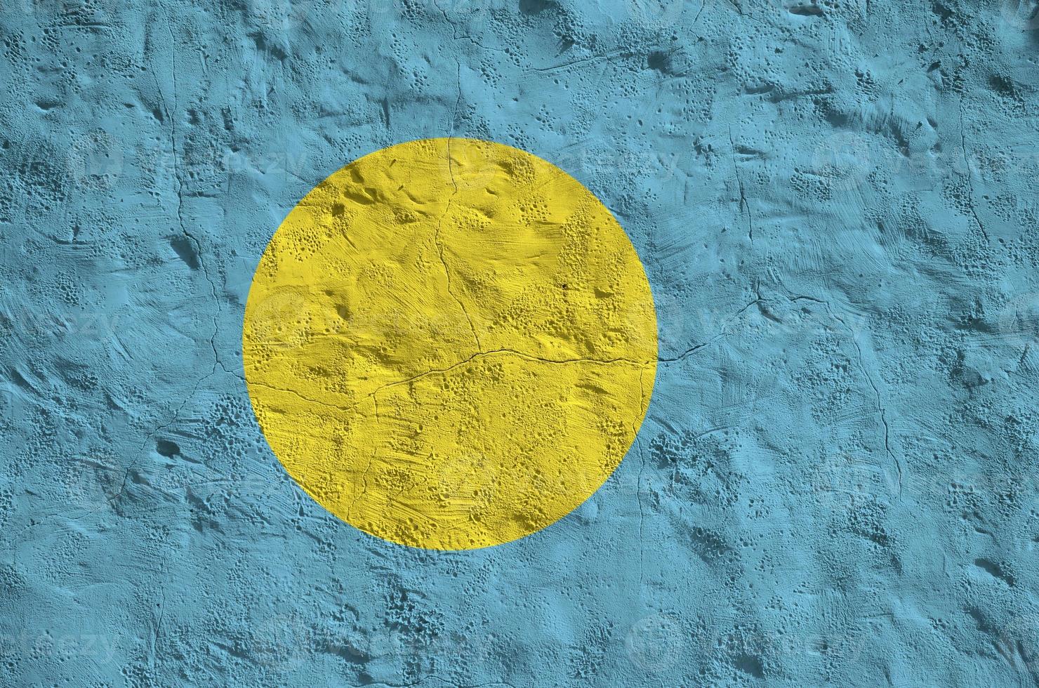 Palau flag depicted in bright paint colors on old relief plastering wall. Textured banner on rough background photo