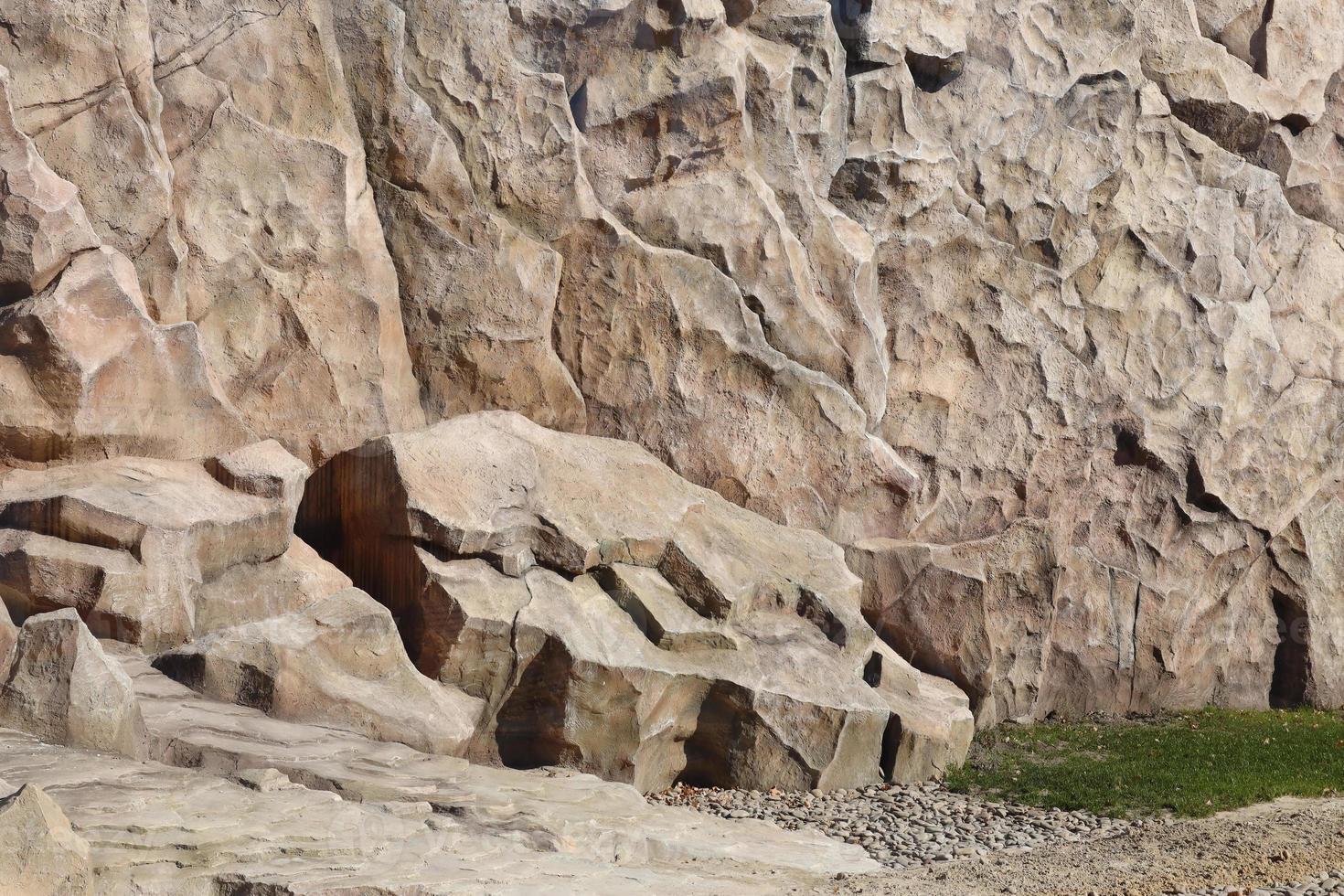 Light coarse natural rock stone background. Mining cliff rough front surface. Big limestone stack backdrop. Heavy grunge damaged granite block texture photo
