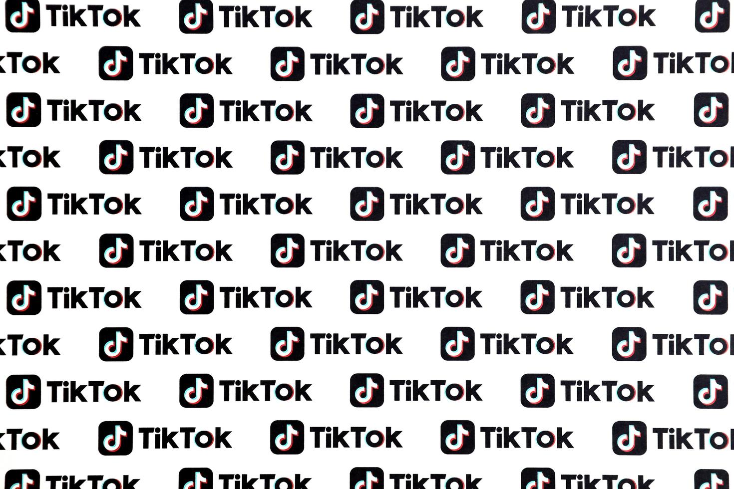 TERNOPIL, UKRAINE - MAY 2, 2022 Many TikTok logo printed on paper. Tiktok or Douyin is a famous Chinese short-form video hosting service owned by ByteDance photo