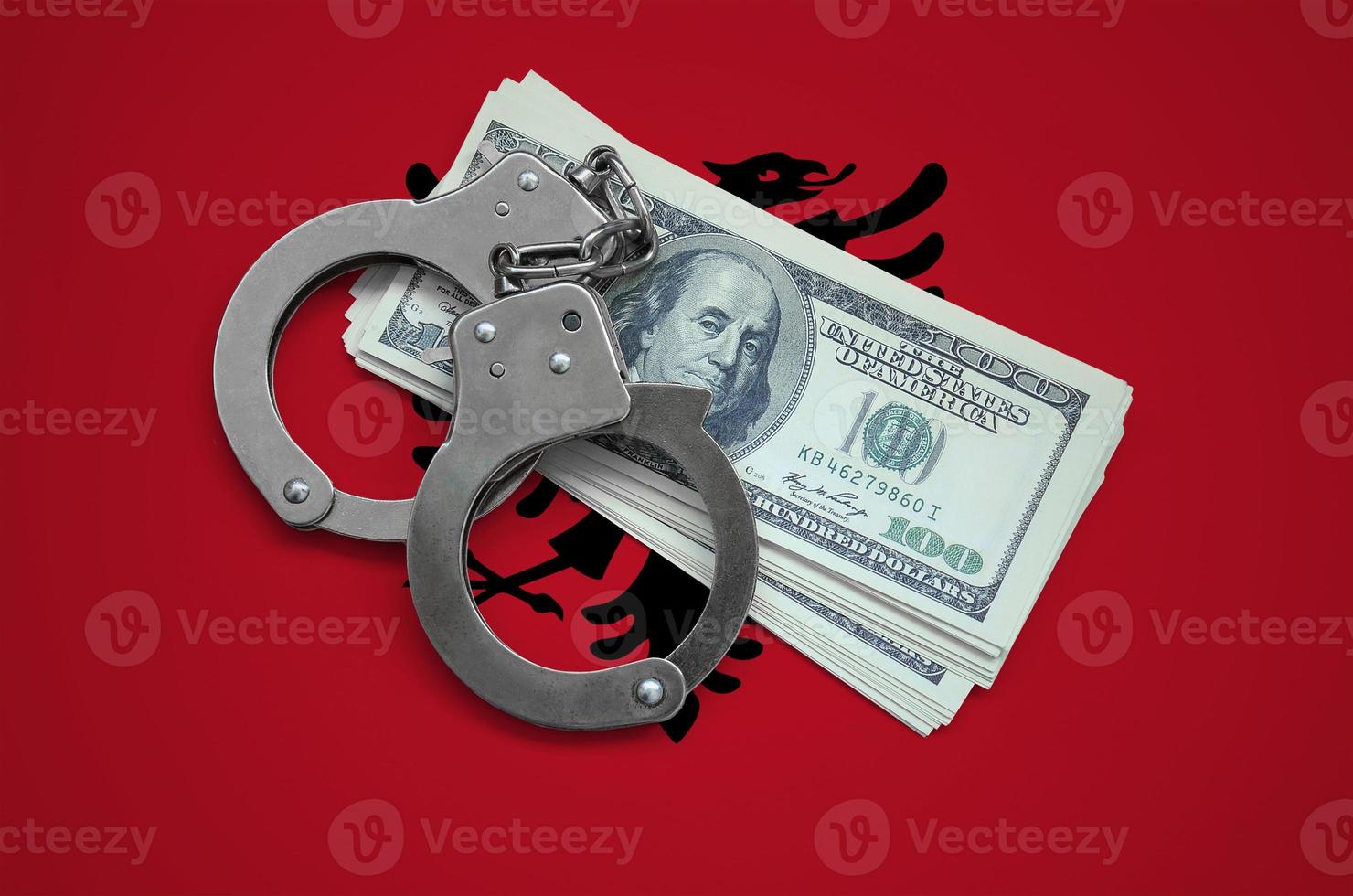 Albania flag  with handcuffs and a bundle of dollars. Currency corruption in the country. Financial crimes photo