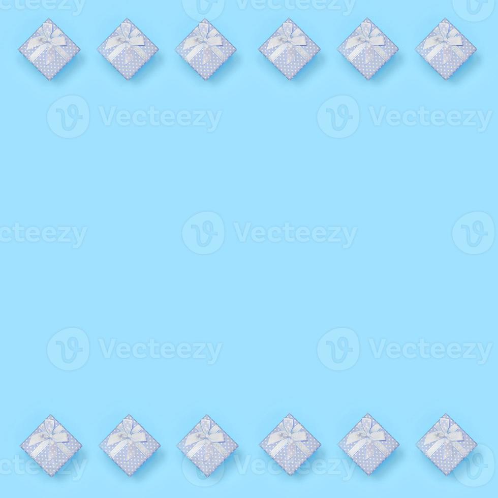 A lot of blue gift boxes lies on texture background of fashion pastel blue color paper in minimal concept photo