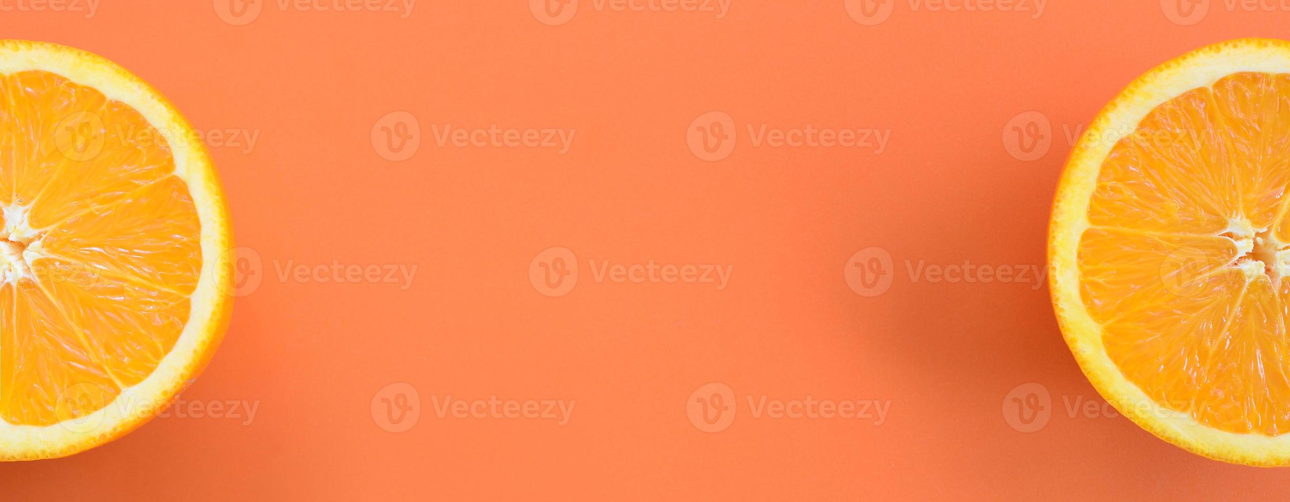 Top view of a several orange fruit slices on bright background in orange color. A saturated citrus texture image photo